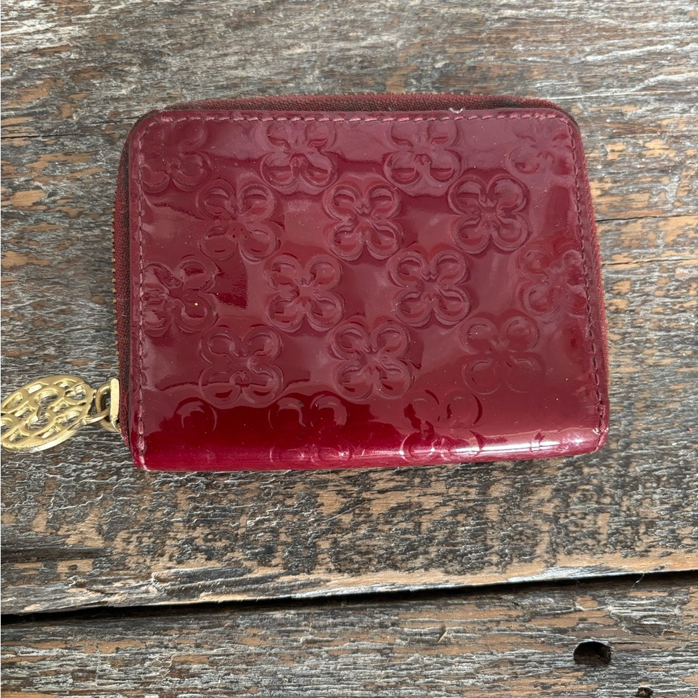 Red patent leather Coach small zip around wallet.